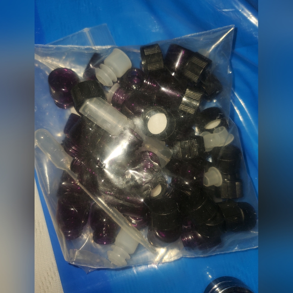 Tiny glass purple bottles